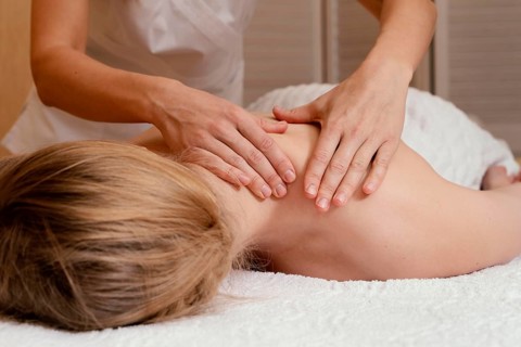 Close up hands massaging woman s back