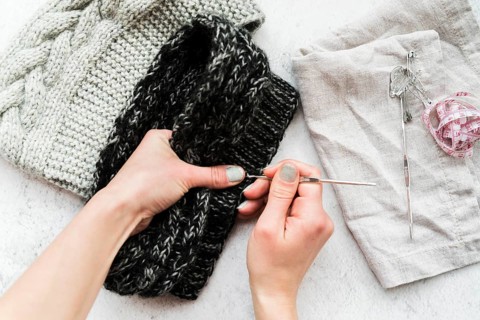 Close up person s hand crocheting with wool