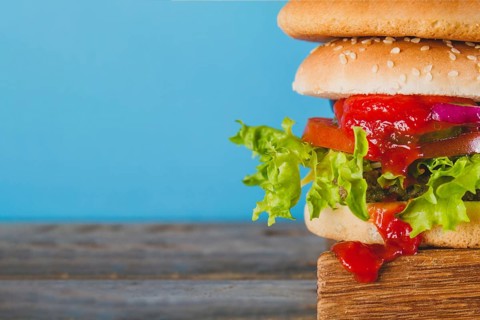Close up tasty burger with tomato sauce