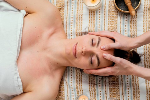 Close up therapist massaging forehead