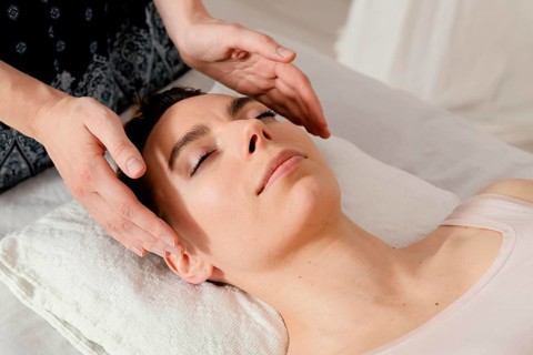 Close up therapist massaging patient s ears