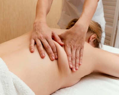 Close up therapist massaging woman s back