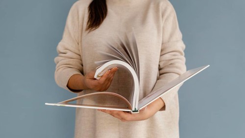 Close up woman browsing through book