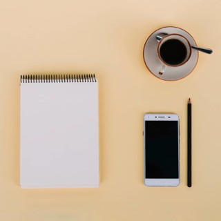 Coffee smartphone near notebook