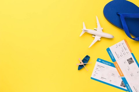 Composition toy airplane boat tickets flip flops