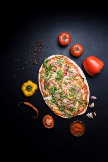 Delicious pizza with ingredients spices wallpaper