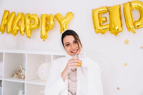 Eid al fitr concept with woman drinking tea