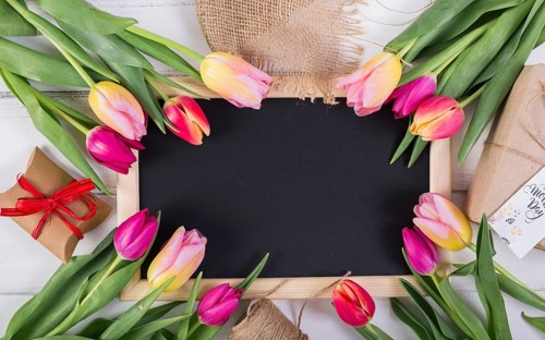 Frame chalkboard decorated by tulips gift boxes