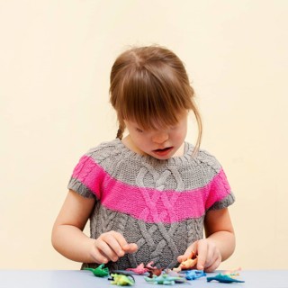 Front view girl with down syndrome toys