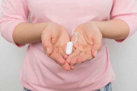 Girl holding clean tampon