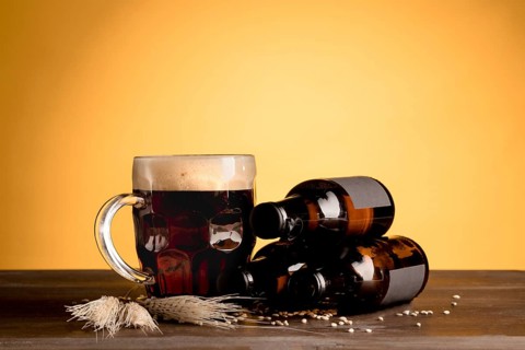 Glass beer with foam bottles beer wooden table