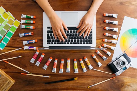 Graphic designer laptop with paint materials