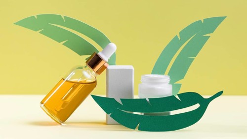 Green leaves with serum bottle