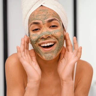 Happy woman having homemade mask her face