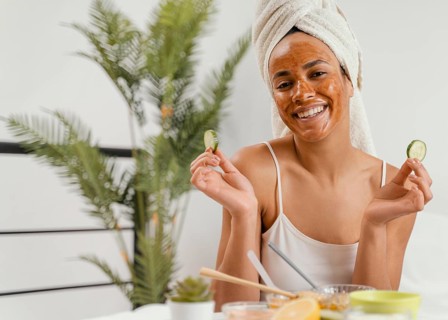 Happy woman using natural face mask