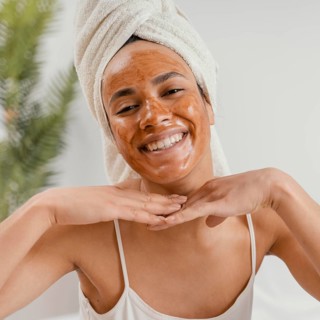 Happy woman using natural face mask 2