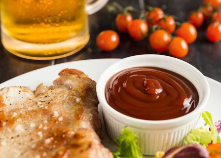 High angle steak plate with ketchup beer