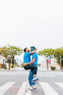 Homosexual couple hugging holi festival