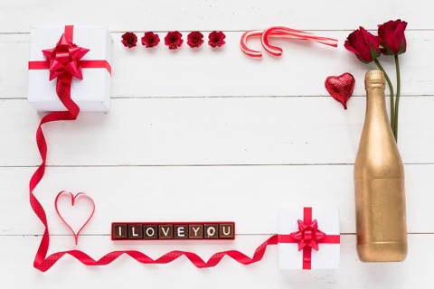 I love you inscription chocolate pieces near presents flowers bottle