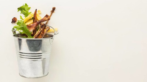 Leftover food waste bucket copy space