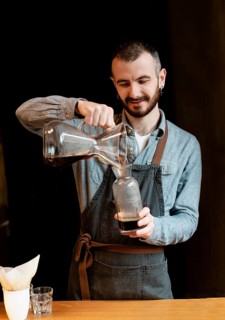 Male preparing coffee customers
