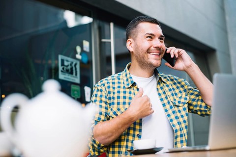 Man emotionally speaking phone cafe