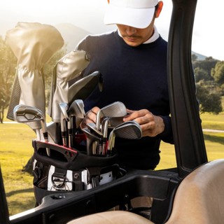 Man putting clubs golf cart
