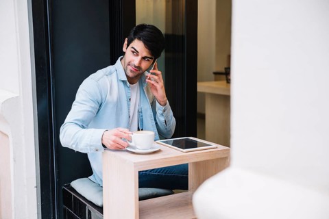 Man talking smartphone sitting cafe
