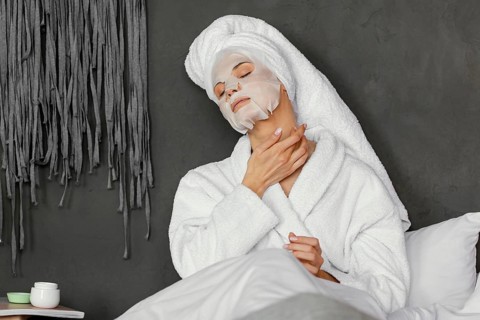 Medium shot woman with facial mask