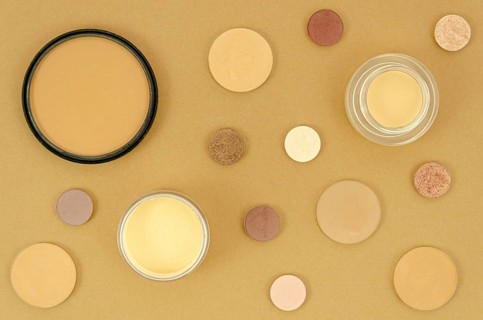 Nude make up products beige background