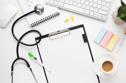 Overhead view medical desk with coffee cup adhesive notes table