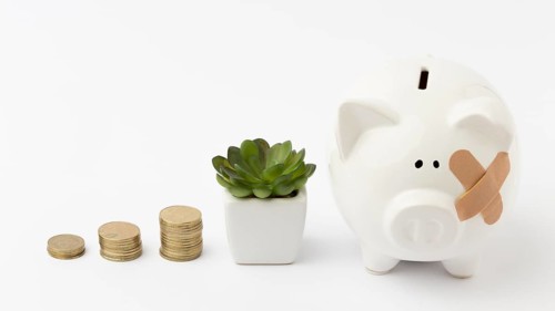 Piles coins broken piggy bank