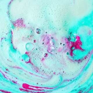 Pink turquoise blue bath bomb dissolving water