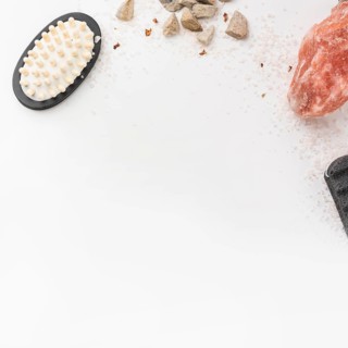 Salt massage brush pumice stone himalayan pink rock salt isolated white backdrop