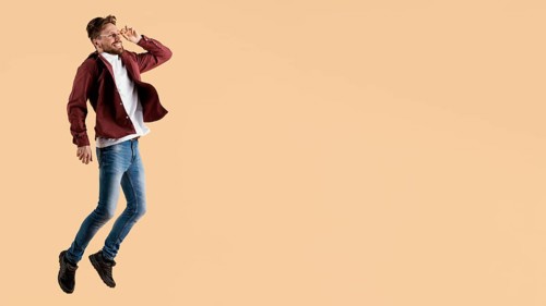 Side view young handsome man jumping