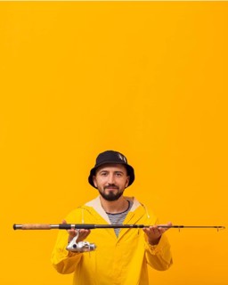 Smiley fisherman holding up fishing rod with copy space