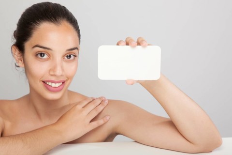 Smiley woman holding card