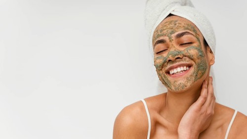 Smiley woman with natural face mask copy space