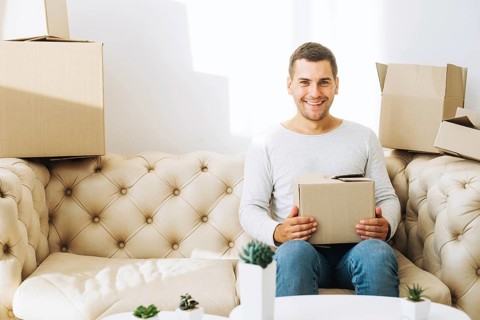 Smiling man with cardboard box