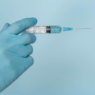 Syringe hands wearing glove