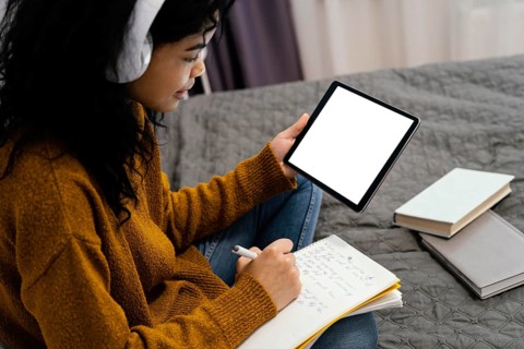 Teenage girl using tablet online school