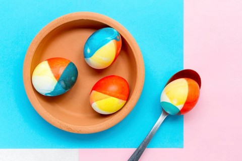 Top view colored eggs easter plate with spoon