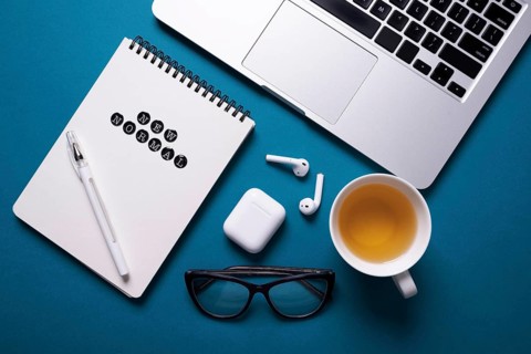 Top view desk with laptop notebook tea