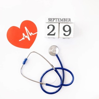 Top view paper heart with date stethoscope