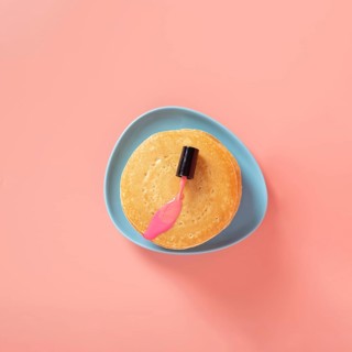 Top view pink nail polish pancakes with plain background