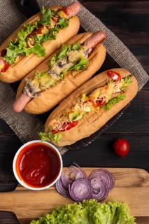 Top view three hot dogs with ketchup onions