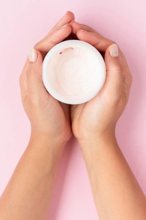 Top view woman holding face cream box