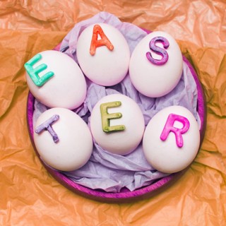 White eggs decorated by letters tray