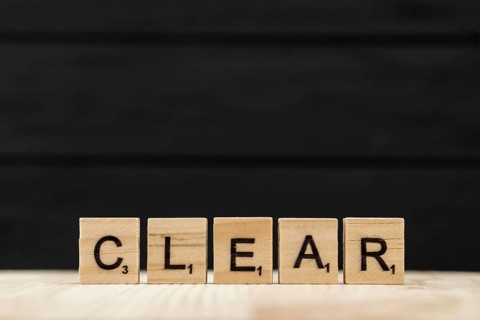 Word clear spelt with wooden letters