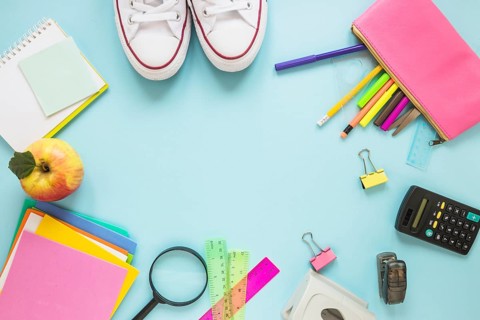 Writing implements sneakers laid circle